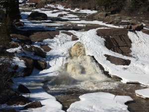 Beaver River flowing through ice