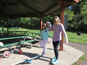 Mya tightrope walking in Pop Up park